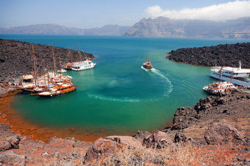 Nea Kameni volcanic island in Santorini, Greece. Ships from Fira