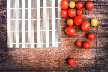 Asian food on the wood background thailand kitchen food. Cooking original eastern top view, wood background texture ,chilli,red tomato, ginger,fish,knife, lemon, onion, bergamot, egg and various.