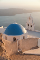 Famous church in Fira, Santorini at sunset with a perfect view o