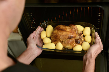 young man preparing a roast turkey