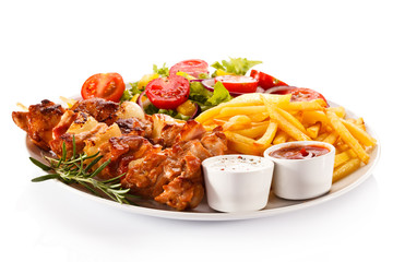 Kebabs - grilled meat and vegetables on white background 