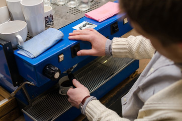 Young man making coffee