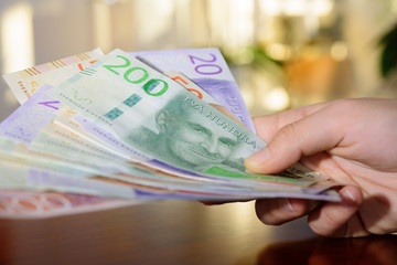 Woman holding new swedish bank notes. NOTE: the new model.