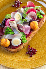 Sandwich with pieces of marinated herring