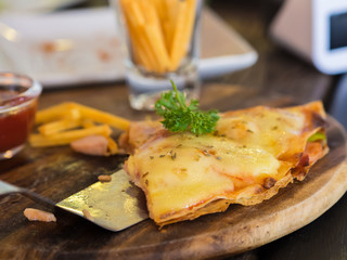 Pizza in wooden tray, On the table.