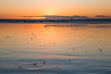 Sunset colors reflecting on the beach