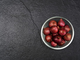 Shallot in a glass bowl with dark background