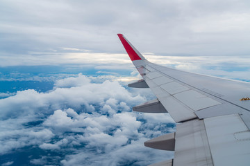 Airplane flying above clouds