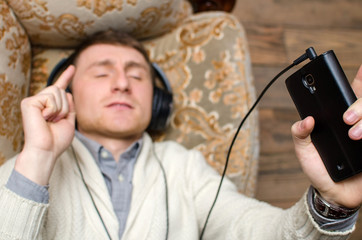Young man is listening music