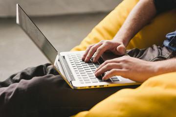Male hands using laptop