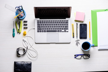 Workplace with laptop and office supplies