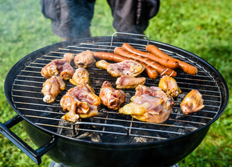 Delicious variety of meat on barbecue grill with char coal.