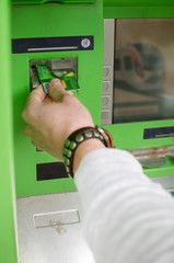 Young man is using cash machine