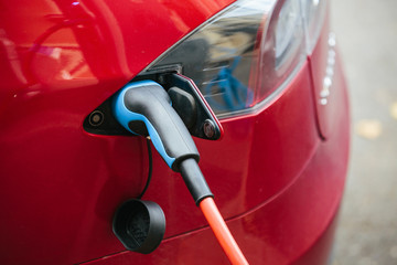 Vehicle with an electric motor. Electric vehicle charging. Eco car.