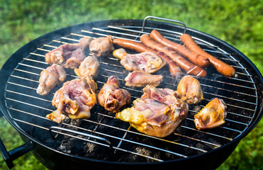 Delicious variety of meat on barbecue grill with char coal.