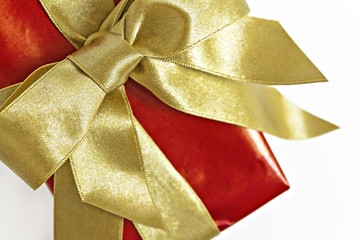 Gift red box with gold ribbon and bow isolated