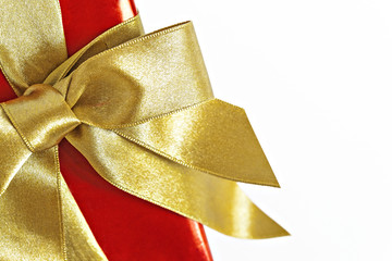 Gift red box with gold ribbon and bow isolated
