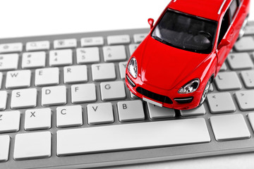 Red toy car on a keyboard