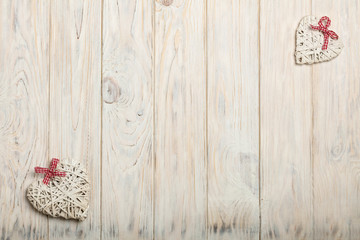 Concept Of Valentine's Day. Wicker hearts on wooden background w