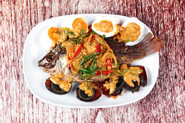 Curry-fried  tilapia fish with preserved egg and salted egg.