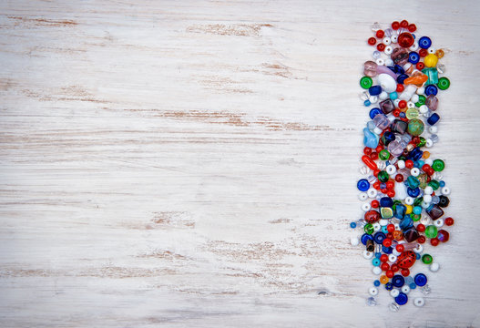 Multicolor Beads On Wooden Background