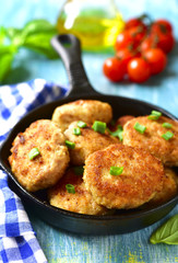 Chicken cutlets in a skillet.