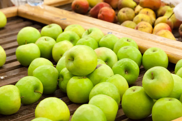 Naklejka na ściany i meble green apples on a counter of shop
