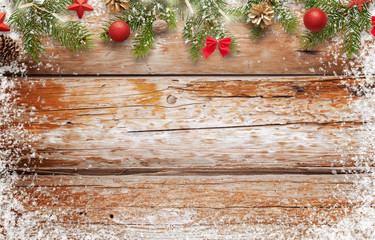 Christmas background image. wooden table with free space for text. Top view of table. Christmas tree and decorations beside.