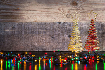 Fototapeta premium Christmas background with decorations tree and lights on wood te