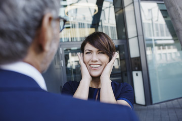 Excited woman looking at businessman