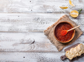 Red caviar in a wooden bowl