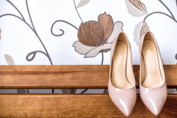 Elegant wedding shoes on back of sofa.
