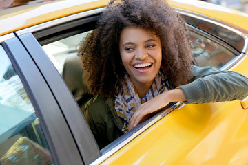 Cheerful girl riding a New York City taxi cab