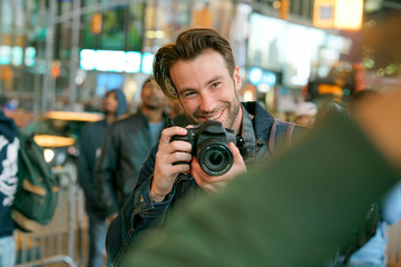 Young man taking picture of girlfriend