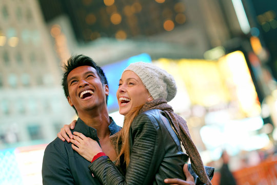 Couple at Times Square laughing outloud