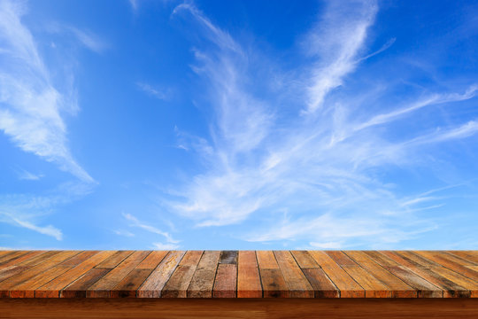 Empty Wooden Table With Blue Sky Background.