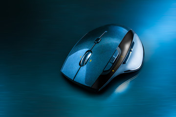 High technology computer gaming mouse in dark blue tone on the metal surface © morkdam