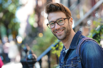 Cheerful man walking in the street, NYC tour