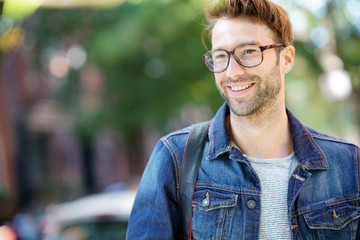 Cheerful man walking in the street, NYC tour