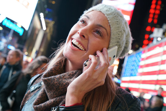 young woman at Times Square talking on phone