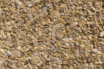 detail of wallcovering with small pieces of different stones texture stone wall