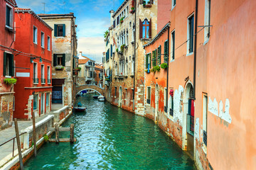 Fototapeta na wymiar Narrow canal with boats in Venice,Italy,Europe