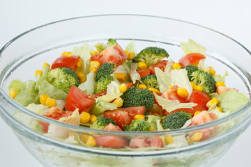 Fresh and healthy salad with tomatoes, broccoli, iceberg lettuce and sweet maize corn