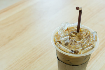 Iced coffee in glass on wood table