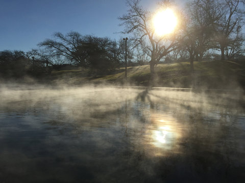 Sunrise over water with steam