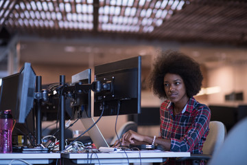 Fototapeta na wymiar young black woman at her workplace in modern office