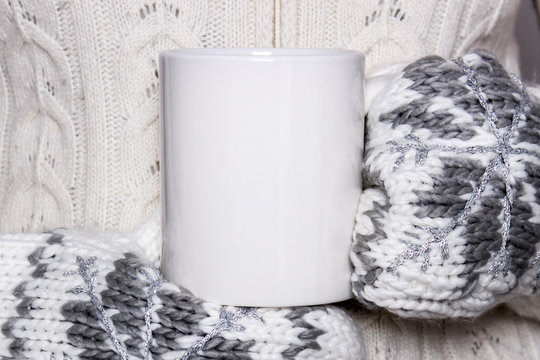 Girl In A Warm Clothes And Mittens Is Holding White Mug In Hands.