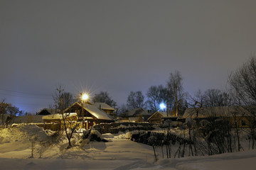 Night and small village in winter snow