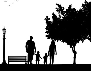 Family walking with their children in park, one in the series of similar images silhouette