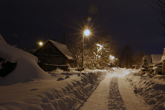 Night and small village in winter snow